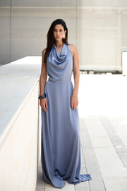 Woman wearing a long light blue dress in an indoor setting